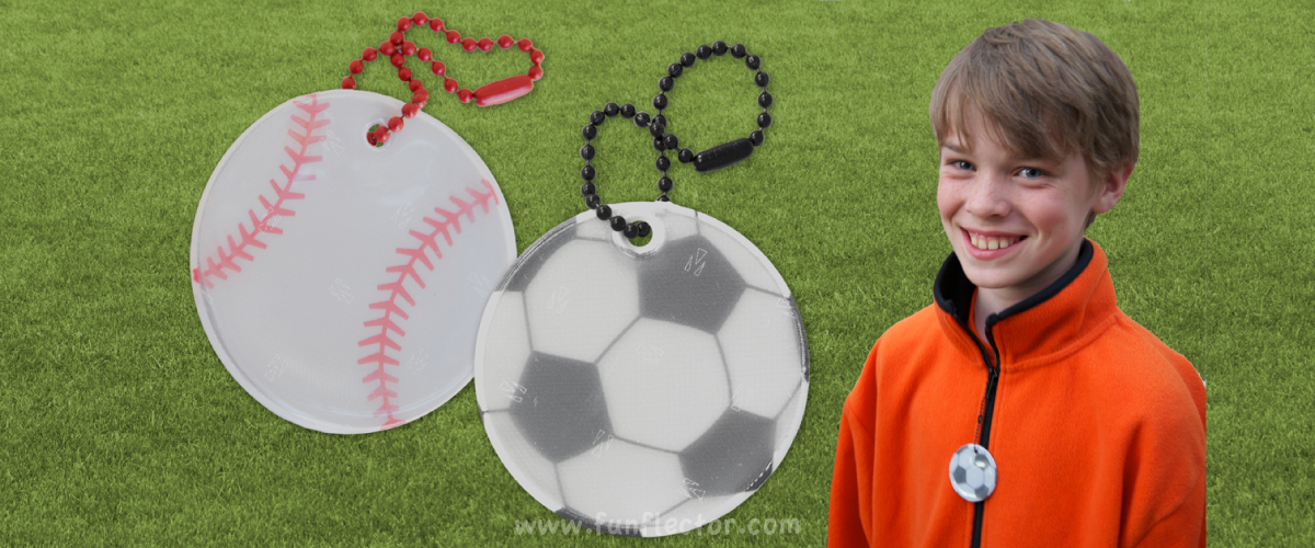 boy with soccer safety reflector and detailed pictures of soccer ball and baseball safety reflectors