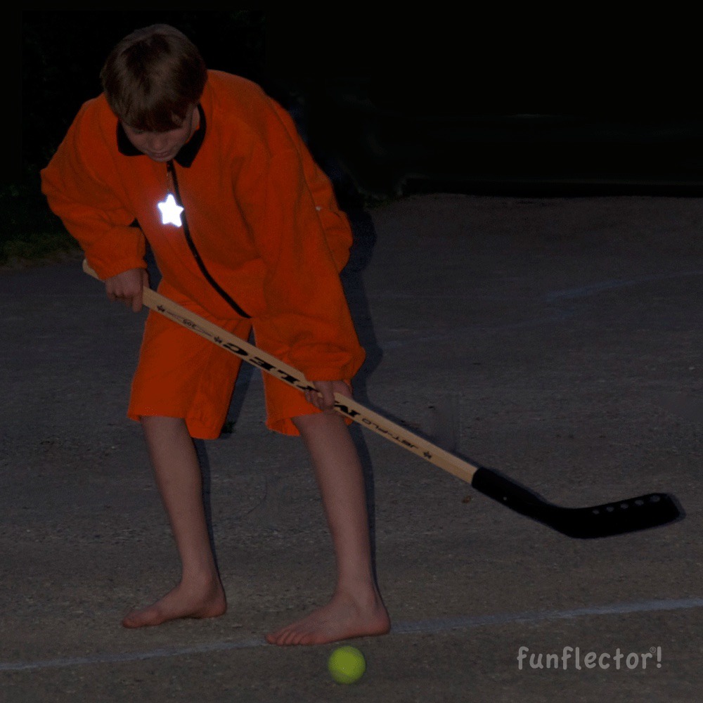 Kid with star safety reflector playing outside
