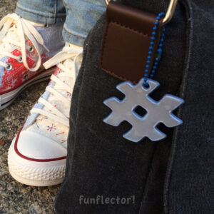 Blue hashtag safety reflector on bag by funflector