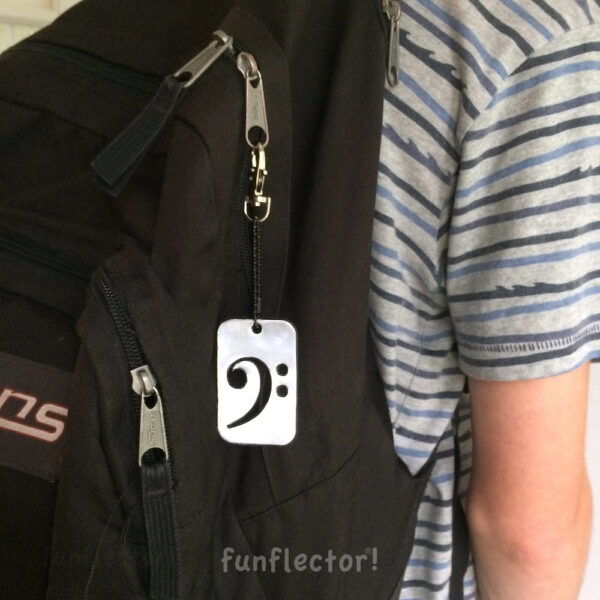 Bass clef safety reflector on backpack