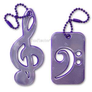 Purple treble and bass clef safety reflector for bags, backpacks and instrument cases