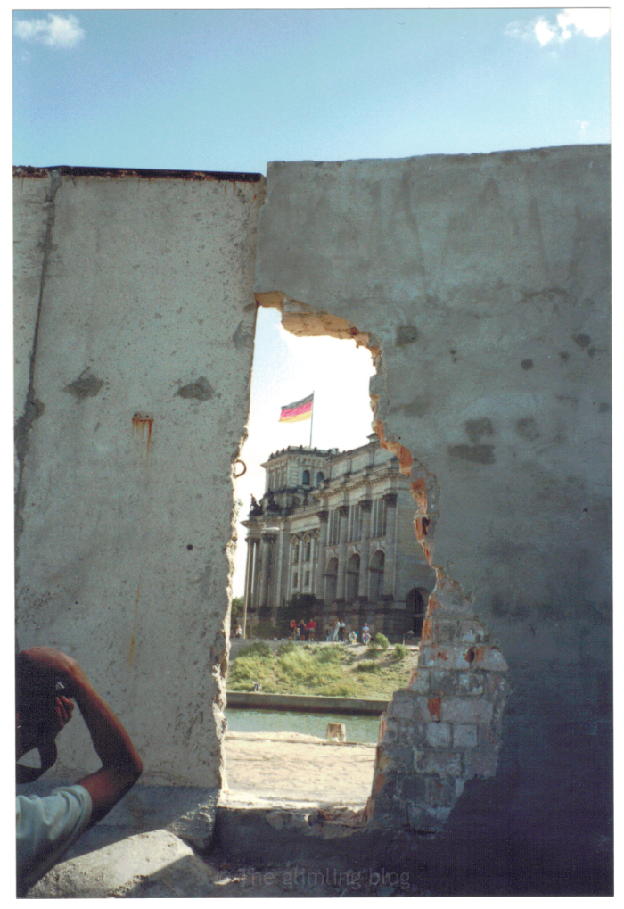 A hole in the Berlin Wall perfectly frames the Reichstag building on the other (west) side.