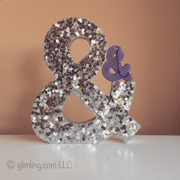 Ampersand home decoration covered in with sequence and purple safety reflector.