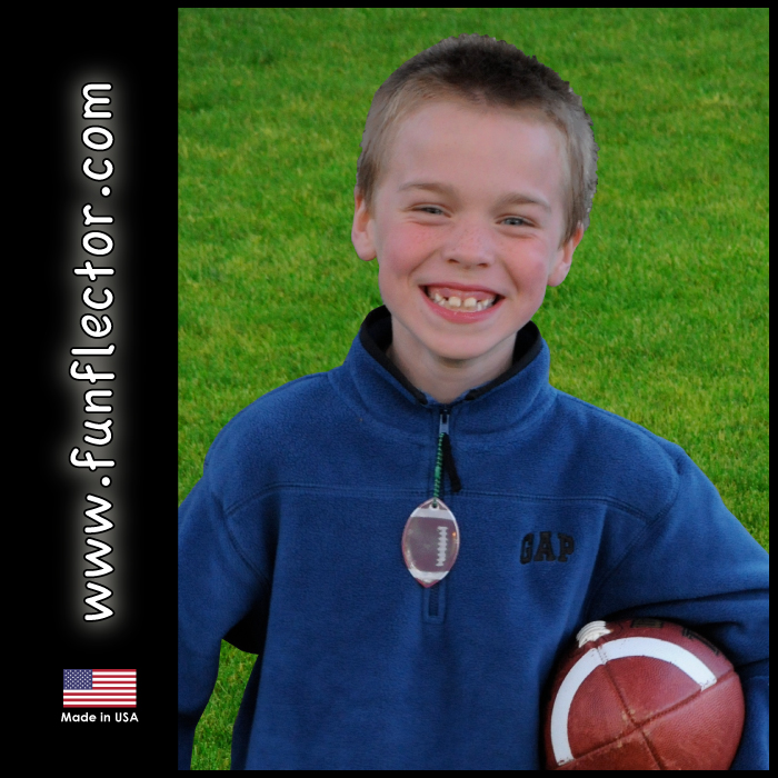 Boy with football safety reflector on fleece jacket