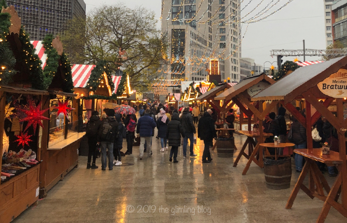 Christmas market at the Kaiser Wilhelm Gedächtniskirche in Berlin on a rainy day.