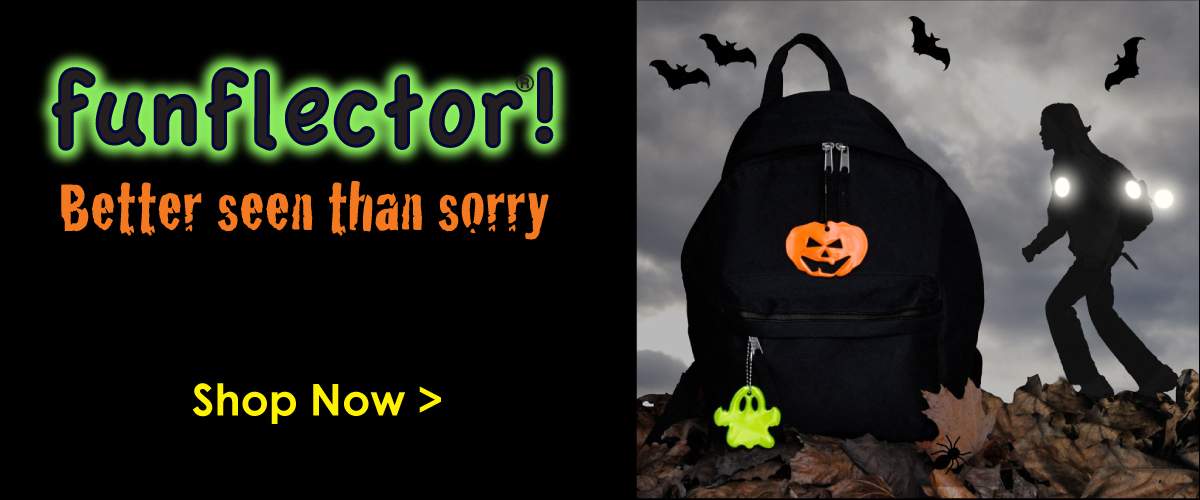 Backpack with Jack O'Lantern and green ghost safety reflectors and girl wearing safety reflectors in the dark.