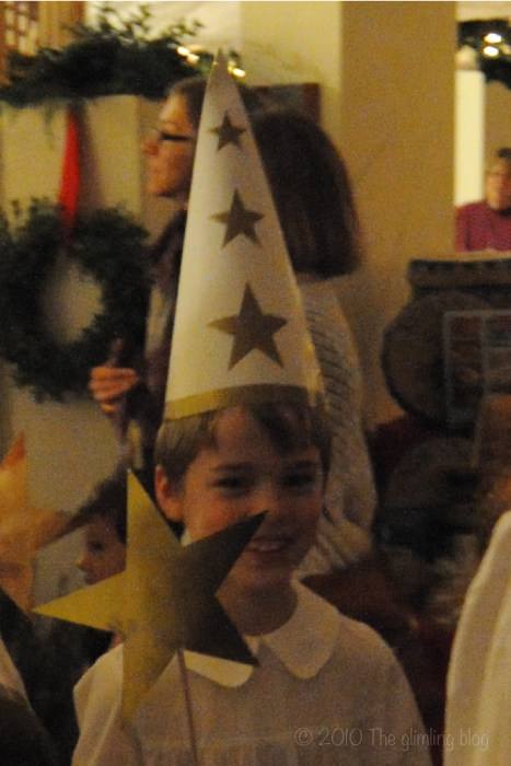 A "star boy" in the Lucia procession add some light to the darkness.
