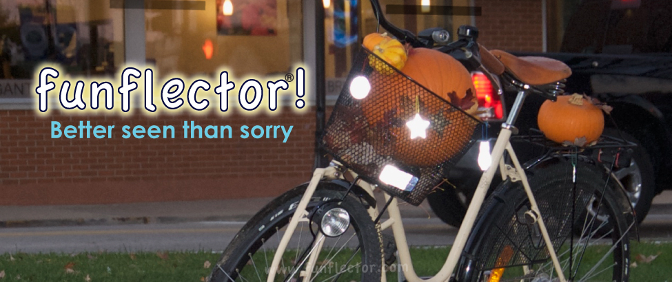 funflector safety reflectors hanging on a bicycle basket full of pumpkins