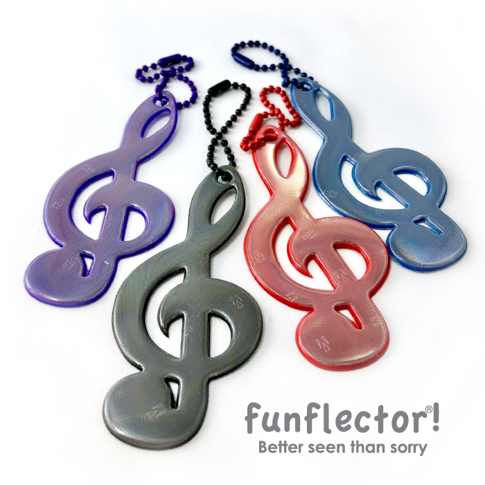 Treble clef safety reflectors in red, purple, blue and black by funflector are great little stocking stuffers for musicians and music lovers.