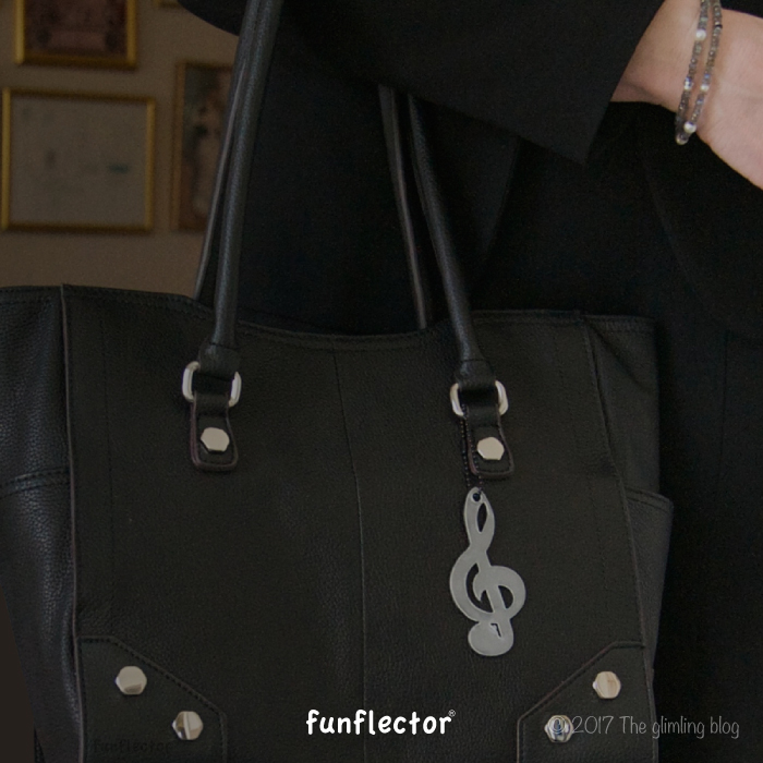 Treble clef safety reflector on purse by funflector